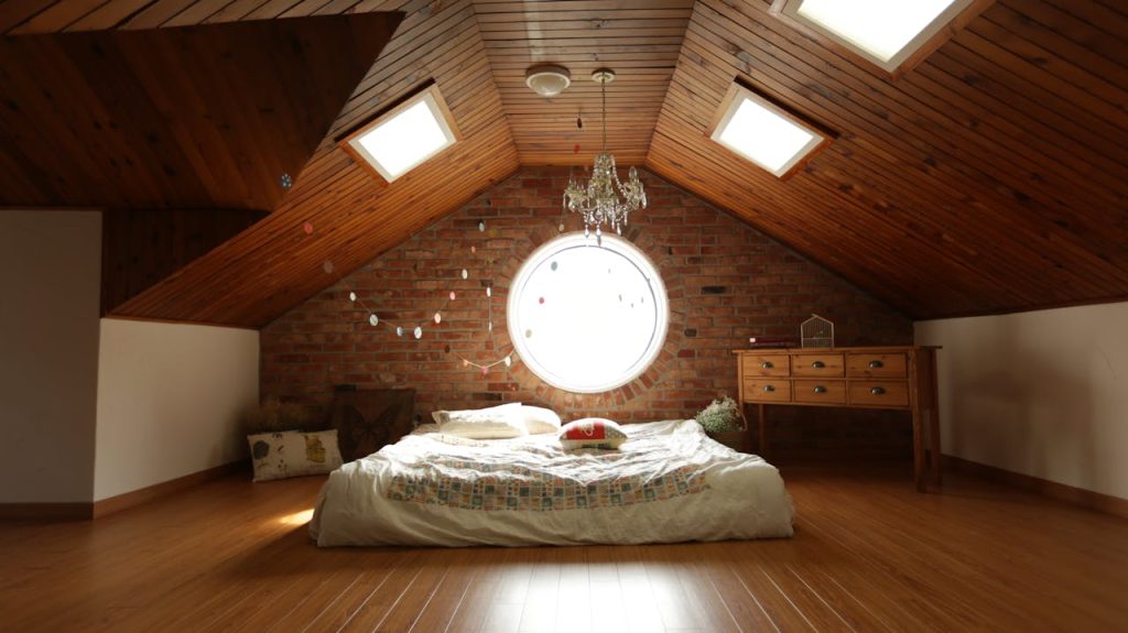 pexels-photo-271743 A warm and inviting attic bedroom featuring a unique brick wall and wooden ceiling design.